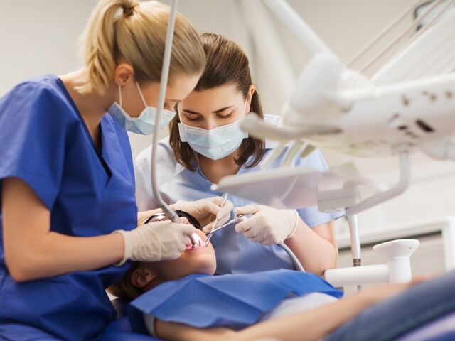Female,Dentists,Treating,Patient,Girl,Teeth