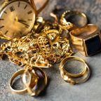 Old and broken jewelry, vintage watches on dark background. Sell gold for cash concept.